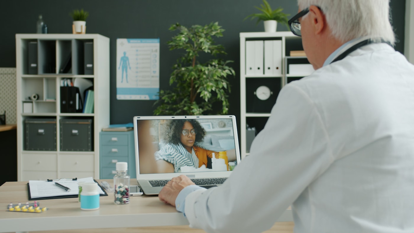 Clinician consulting a patient by video call